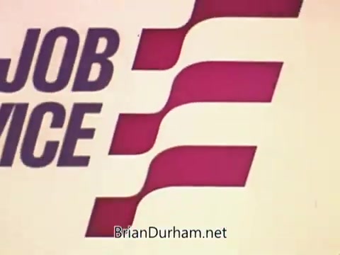 The still features bold, stylized text reading 'JOB SERVICE,' prominently displayed in purple and red colors. The design incorporates abstract shapes or waves that convey movement and dynamism, reflecting a professional and inviting tone. The overall aesthetic suggests a 1970s vintage look typical of public service announcements from that era.