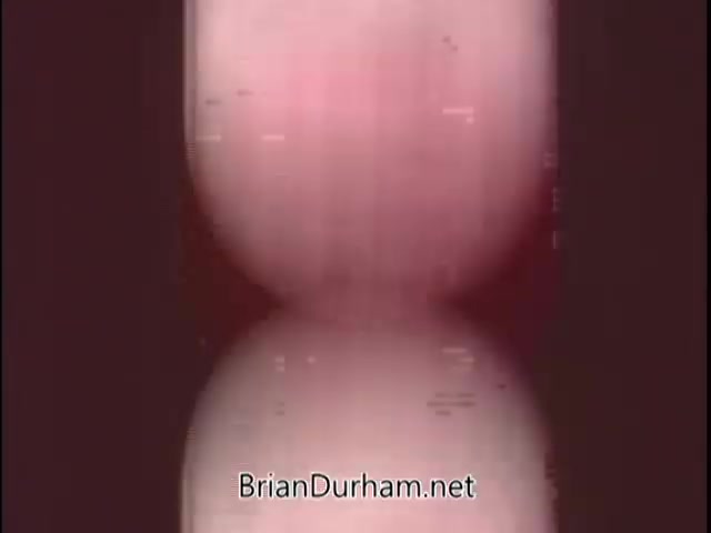 The still features a blurred, abstract image with a gradient of pink and white tones. The focus appears to be on a round shape, possibly representing a coin, reflecting in a surface below. The overall aesthetic is soft and dreamlike, fitting the promotional context for the Silver Bicentennial coins. The watermark at the bottom indicates the source of the image.