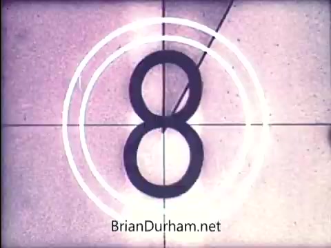 The still features a vintage film countdown, specifically showing the number '8' in a circular overlay. The background appears to have a tiled floor, characteristic of the early 1970s aesthetic. The overall look suggests a retro film presentation likely introducing or transitioning to content related to the 'Lazy Dazy' doll from Ideal.