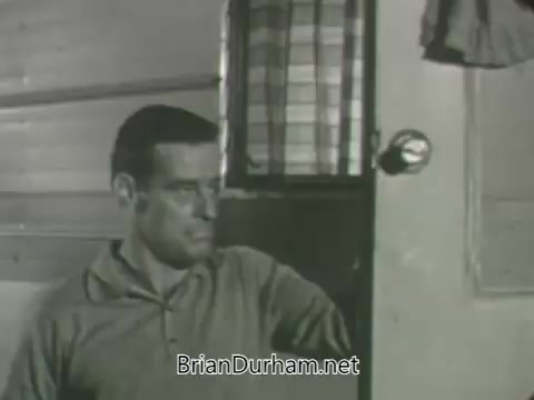 The still depicts a man seated beside a door with a glass doorknob, set against a backdrop of wooden paneling and a checked curtain. His expression suggests contemplation or concern, and the monochromatic tone emphasizes the retro aesthetic typical of early television promotions. This imagery is part of the ABC Fall 1963 season promos, evoking the era's style and thematic elements.