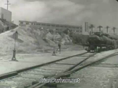 The still features a black-and-white scene set by a railway track with a figure walking along it. In the background, there are piles of earth and an industrial building. The overall mood is gritty and reflective of mid-20th century Americana. It's part of a promotional sequence for ABC's Fall 1963 season, likely aiming to evoke themes of progress and change.