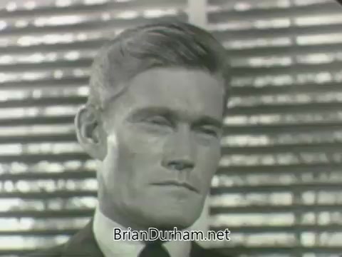 The still features a close-up of a man with a serious expression, set against a backdrop of horizontal blinds. His hairstyle is neatly combed, and he is dressed in a suit and tie, suggesting a formal context. The lighting emphasizes his facial features, suggesting tension or contemplation. This image is likely part of a promotional piece for ABC's 1963 fall season.