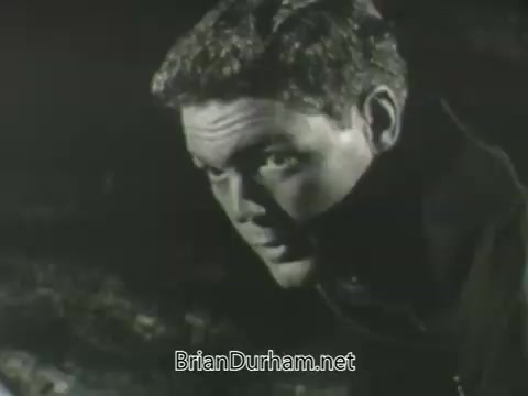 The still features a close-up of a male character, capturing his intense expression. The lighting creates dramatic shadows, emphasizing his facial features. He appears to be in a moment of contemplation or concern, with a blurred background suggesting a tense or pivotal scene. The overall tone is atmospheric, characteristic of promotional material from the 1963 ABC fall season.