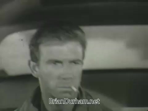 The still depicts a serious male character sitting inside a car, smoking a cigarette. The black-and-white image suggests a dramatic or tense scene, common in promotional materials from the 1960s. The expression on the character's face indicates intensity, likely emphasizing a narrative moment from a TV show or film featured in the ABC Fall 1963 season promos.