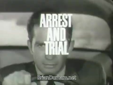 The still features a close-up of a man driving a car, with a focused expression. The words 'ARREST AND TRIAL' are prominently displayed in bold, white font over the image. The scene is likely a promotional clip for the ABC television show's Fall 1963 season, suggesting themes of law enforcement and courtroom drama. The visual style reflects the era's cinematic techniques.