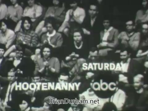 The still features an audience clapping and enjoying a performance, with the text displaying 'HOOTENANNY' and 'SATURDAY' prominently on the screen. The promotional image is styled in a vintage format typical of the 1960s, emphasizing a lively atmosphere for the ABC program scheduled for that season.
