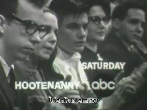 The still features a group of young individuals seated, likely in a studio audience, with a retro aesthetic typical of the early 1960s. In the foreground, they appear engaged or clapping. The text overlay reads 'SATURDAY' and 'HOOTENANNY,' along with the ABC logo, promoting the show scheduled for that time. The overall tone is upbeat and nostalgic, capturing the spirit of television programming from that era.