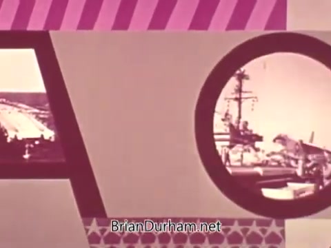 The still features a graphic layout with bold letters 'AOC' prominently displayed. Surrounding them are circular images depicting scenes related to US Navy aviation, including aircraft and a naval ship. The design incorporates vibrant colors and patterns, typical of mid-20th century promotional materials. This frame represents a segment of a public service announcement aimed at recruitment for Navy aviation careers.