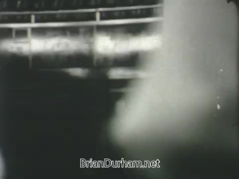 The still from the 'US Army ROTC commercial - 1968' depicts a blurred scene, possibly at a military or athletic event. The focus is unclear, suggesting movement or energy, typical of promotional materials aimed at highlighting the vibrancy and excitement associated with military training programs. The overall tone is likely nostalgic, reflecting the era of the late 1960s.