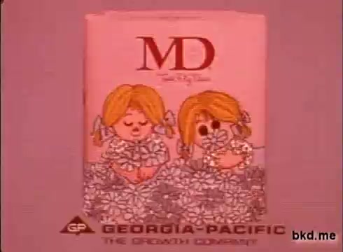 The still features a vintage advertisement for 'MD' toilet tissue from the 1970s. It showcases a colorful package adorned with cartoonish illustrations of two cheerful children surrounded by flowers. The branding includes the Georgia-Pacific logo, emphasizing its slogan 'The Smoothest Quality.' The overall aesthetic reflects the playful design trends of that era.