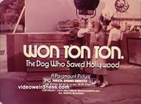 The still features the title 'Won Ton Ton: The Dog Who Saved Hollywood' prominently displayed. It's a colorful promotional image from a 16mm print of a movie trailer. The background hints at a film set, with people in period attire, reflecting the comedic and nostalgic nature of the film. The trailer is presented by Paramount Pictures and carries a PG rating.