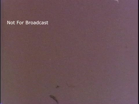 The still appears to be a monochromatic image, possibly showing a blank or poorly exposed scene, with visible scratches and marks typical of vintage film. The text 'Not For Broadcast' indicates it is a private or unreleased segment from the US Coast Guard's public service announcement from the 1970s.