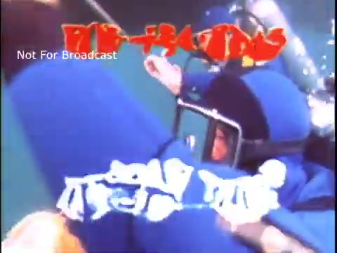 The still likely depicts a scene from a 1970s US Coast Guard public service announcement (PSA). It features individuals in blue wetsuits, possibly involved in underwater rescue or safety operations. The text 'Not For Broadcast' suggests it is an archival or promotional clip, emphasizing its informative nature about Coast Guard activities and safety measures.