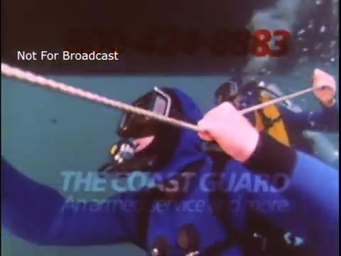 The still shows a diver in a blue wetsuit, gripping a rope underwater. Another diver is visible in the background. The image is part of a U.S. Coast Guard public service announcement from the 1970s, emphasizing marine safety and rescue operations. The text at the bottom reads: 'THE COAST GUARD, America’s service 24 hours.'