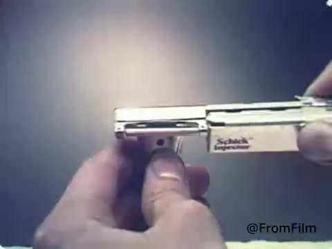 The still from the 'Schick Injector Razor Blades - 1970's' shows a close-up of a Schick injector razor blade device. A person's hand is positioned near the razor, demonstrating its mechanism. The focus is on the razor's injector system, emphasizing its design and functionality. The background is neutral, directing attention to the razor and highlighting the vintage aesthetic typical of the 1970s advertising style.   Follow us on Twitter @FromFilm.
