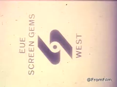 The still features the logo of Screen Gems, a production company, often seen at the beginning of films and commercials. It likely serves as an introduction to a vintage advertisement, emphasizing the association with quality. The context involves a girl reading about making Toll House Cookies using Nestlé semi-sweet chocolate chips, highlighting their key role in creating delicious homemade cookies. The voiceover reinforces the idea that these ingredients make for a special baking experience.