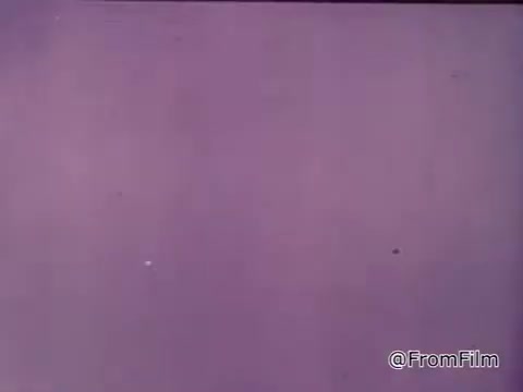 The still from the 1970s Nestlé semi-sweet chocolate chips commercial features a girl reading from a package of Toll House cookie ingredients. The voiceover emphasizes the appeal of fresh, homemade Toll House cookies, highlighting the deliciousness of Nestlé's semi-sweet morsels, and mentions that the recipe is included on the package. The ad conveys a nostalgic and warm vibe, targeting cookie lovers and home bakers.