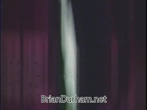 The still from the 1971 Jell-O Pudding in a can commercial features a visual presentation typical of the era, likely showcasing the product's packaging or preparation. The background suggests an indoor setting, perhaps with curtains, which adds a domestic feel. The focus might be on the convenience and appeal of the pudding in can form, aligning with advertising strategies of that time to highlight easy meal solutions. Overall, it captures the essence of 1970s food marketing.