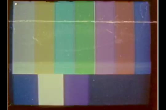 The image displays a series of vertical color bars with varying shades, typical of test patterns used in video equipment. The colors range from green, blue, and purple to yellow and white, indicating an electronic broadcast format. The overall presentation lacks specific content related to the CBS News story by Bill Plante from 1970, focusing instead on the technical aspect of the film medium. Scratches and wear may suggest the negative's age and previous handling.
