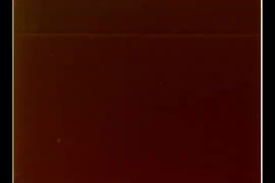 The 16mm still from 'CBS - Bill Plante Christmas/Santa Story - 1970' likely depicts a scene related to the annual department store Santa visit, showcasing the integration of technology in a festive setting. The visual quality may feature a warm, nostalgic tint typical of that era, reflecting the ambience of a 1970s Christmas shopping experience. The context involves Bill Plante reporting on the innovative methods being employed by the department store to enhance children's interactions with Santa.