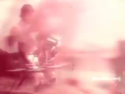 The still from the 'Pabst Beer Commercials - 1970s' features a couple enjoying a relaxed outdoor setting with drinks on a table. The scene is likely vibrant and casual, capturing the essence of social gatherings from that era. The image's color and quality reflect the characteristics of 16mm film, adding a nostalgic feel typical for commercials of the time.