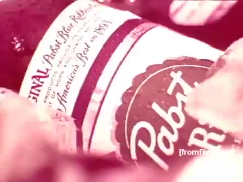 The still features a close-up of a Pabst Blue Ribbon beer bottle, prominently displaying the iconic label. The background includes ice or water droplets, evoking a refreshing vibe typical of beer advertisements from the 1970s. The overall aesthetic reflects vintage commercial styles, emphasizing the brand's heritage and quality.