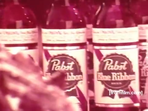 The still features several bottles of Pabst Blue Ribbon beer, prominently displaying the brand's label. The focus on the labels suggests an emphasis on the product. The image likely comes from a commercial context, highlighting the beverage in a nostalgic 1970s aesthetic. The overall arrangement evokes a sense of retro marketing typical of that era.