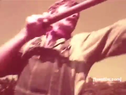 The still from the 1970s Pabst Beer commercials features a man in overalls, energetically using a long pole or tool. The brightness and color tone suggest a nostalgic, vintage feel typical of that era’s advertising style. The background likely depicts an outdoor scene, aligning with themes of authenticity and craftsmanship often promoted in beer commercials of the time.