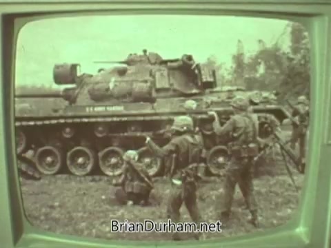 The still features a vintage television display showing a scene from the 1960s featuring soldiers interacting near a tank. The image likely reflects themes of conflict or military presence, possibly serving as a backdrop for the PSA's message from the Episcopal Church during that era. The tone is serious, likely addressing societal issues relevant to the time.