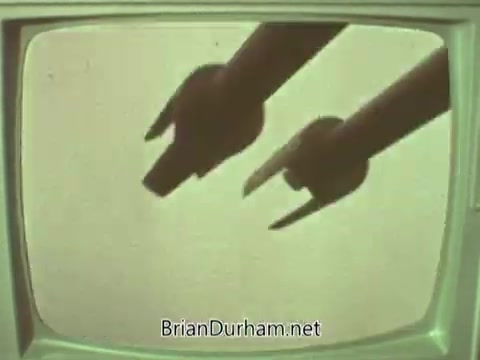 The still features two hands making gestures, possibly pointing, against a muted backdrop visible on an old television screen. The visual aesthetic suggests a vintage style typical of the 1960s. The context implies a public service announcement from the Episcopal Church, likely aimed at communication or outreach.