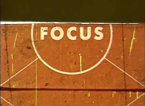 The 16mm still from 'The Human Cell and the Cytologist' features the word 'FOCUS' prominently displayed in a circular design against a textured, likely film-worn background. The visual elements suggest a classic education theme, possibly related to microscopy or cellular studies. The overall appearance indicates it is part of a larger sequence intended to engage viewers in biological concepts.