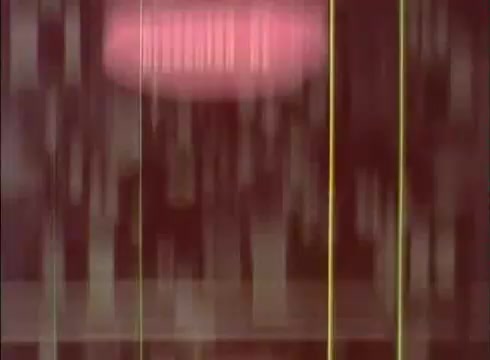 The still from 'The Human Cell and the Cytologist' likely features a blurred or abstract representation typical of 16mm film. The image may include color gradients and vertical lines, suggesting a focus on cellular structures or processes within an educational context. It captures the essence of scientific exploration while possibly emphasizing visual engagement rather than detailed clarity.