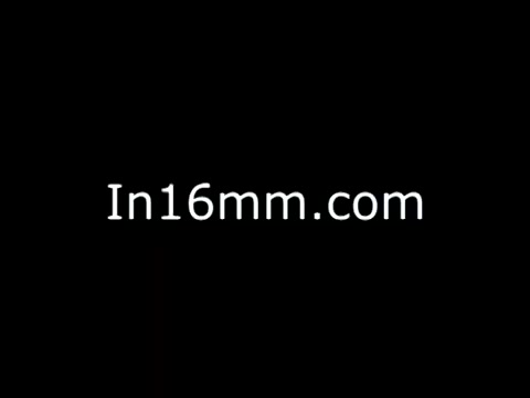 The still features a simple black background with text reading 'In16mm.com.' This indicates it's related to a platform focused on 16mm film content, possibly previewing or showcasing material related to 'John Denver PSA - Presidents Council on Physical Fitness and Sports.' The context suggests a promotion of health and fitness awareness through Denver's involvement.