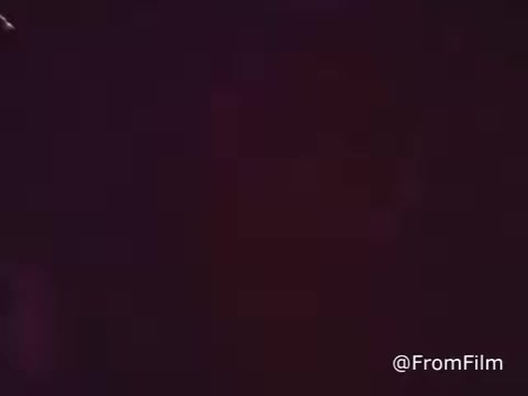 The still from the 1969 American Cancer Society PSA appears to depict a wedding reception setting. The dim lighting and ambiance suggest a celebratory atmosphere, likely filled with guests enjoying the event. As it is a public service announcement, it may also contain messages related to cancer awareness or prevention, intertwining these themes with the joyous occasion of a wedding. The 16mm print gives it a vintage feel characteristic of that era.