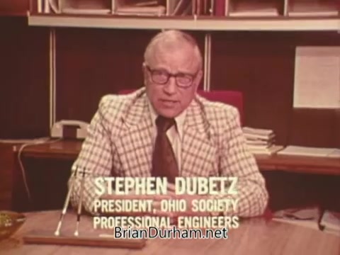 The still features Stephen Dubetz, identified as the President of the Ohio Society of Professional Engineers, seated at a desk. He is delivering a message regarding voting against Issue Six, a political advertisement related to nuclear power in Ohio. The setting reflects a professional environment, with shelves and office materials visible in the background. The focus is on Dubetz as he communicates the campaign's stance.