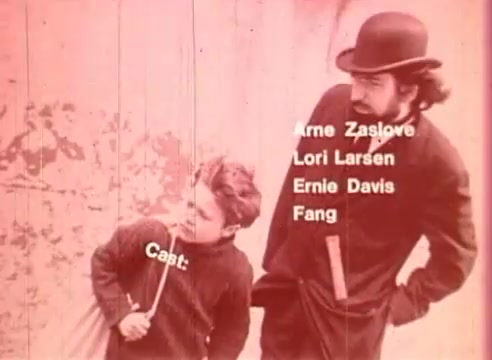 The still from 'Erik Satie and the King of the Beans - Part II' features two characters: a young boy holding a stick and a man in a bowler hat with a mustache. The scene is framed against a textured background, and the cast list appears prominently on the left side. The overall color scheme has a pinkish tint, contributing to the film's vintage aesthetic.