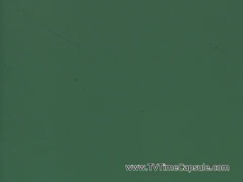 The still from 'Army Recruiting Commercial - Your Man in Waikiki' appears to be a simple green background. The image suggests a minimalist design typical of some advertising styles, potentially used to focus attention on accompanying text or voiceover, emphasizing a call to action for army recruitment. The commercial likely portrays an appealing lifestyle associated with military service while featuring elements of Hawaiian culture.