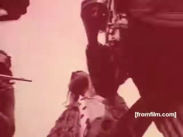 The still from the Souza Cruz Brazilian cigarette commercials of the 1970s depicts a dramatic, stylized scene likely aimed at evoking a strong emotional response. The use of sepia tones adds a vintage feel, while the focus on individuals, possibly in a social or adventurous context, reflects the marketing tactics of the time, promoting cigarettes as symbols of sophistication or allure. The composition suggests a narrative moment, typical of advertisements from that era, aiming to connect the product with a lifestyle or aspirational image.