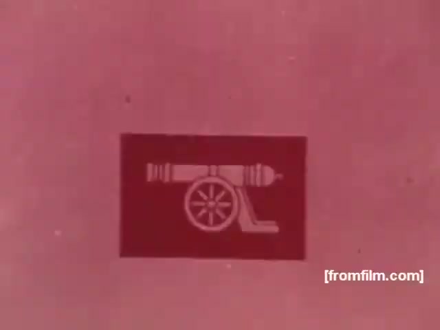 The still features a stylized graphic of a cannon against a pink background. This imagery likely aimed to evoke themes of strength and tradition, common in advertising for tobacco products during the 1970s. The simplicity of the design reflects the aesthetic of the era, capturing attention without clutter. Overall, it represents a bold visual associated with the Souza Cruz brand's marketing strategies for their cigarette lines, such as Albany and Richmond.