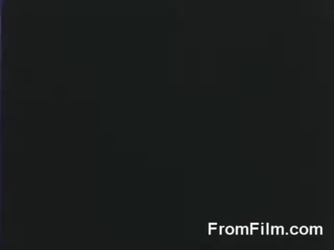 The still is a 16mm film frame capturing a moment from the Doolittle Raid, showcasing B-25 bombers preparing for launch from the USS Hornet on April 18, 1942. The scene likely conveys the tension and determination of the raiders as they embark on a historic military mission against Japan during World War II.