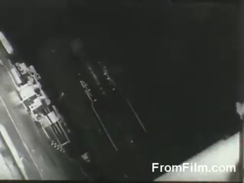 The still shows a black-and-white perspective of the USS Hornet's flight deck, where B-25 bombers are positioned for their launch. The image captures the moment just before the Doolittle raiders take off on their mission to strike Japan, highlighting the intensity and urgency of this historic military operation on April 18, 1942.