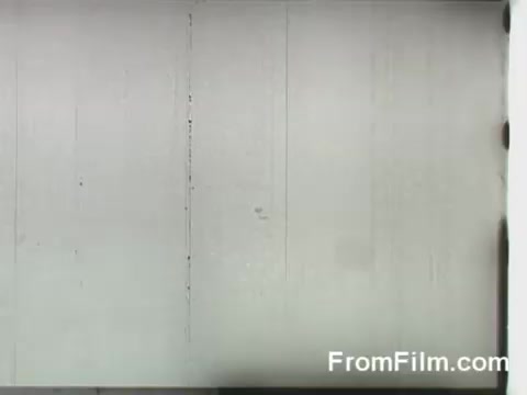 The 16mm still captures a moment from the Doolittle Raid, showing B-25 bombers being launched from the USS Hornet. This historic event occurred on April 18, 1942, during World War II, marking a significant retaliatory airstrike against Japan. The image likely conveys the intensity and urgency of the mission as the aircraft prepare for takeoff.