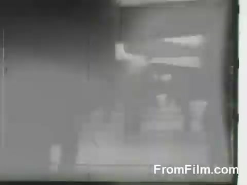 The still captures a moment from the Doolittle Raid, showing B-25 bombers being launched from the USS Hornet. The image likely features military personnel preparing the aircraft for takeoff, reflecting the urgency and historical significance of the April 18, 1942 mission. The scene conveys a sense of action and determination against the backdrop of World War II.