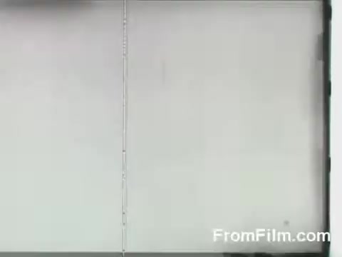 The still from 'FromFilm.com - Doolittle Raid Footage' likely depicts a moment from the historic Doolittle Raid on April 18, 1942, where B-25 bombers launched from the USS Hornet. The 16mm film captures the tension and anticipation of the crew as they prepare for their mission. The image may convey the atmosphere aboard the aircraft carrier during this pivotal moment in World War II, showcasing the bravery and determination of the raiders.