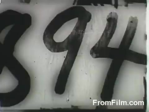 The still features a close-up of the numbers '894,' likely indicating a specific aircraft or mission identifier related to the Doolittle Raid. This suggests a focus on the preparations and details surrounding the launch of B-25 bombers from the USS Hornet on April 18, 1942. The visual emphasizes the historical significance of the event.