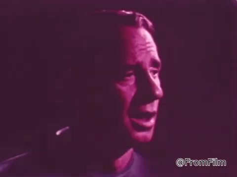 The still features a man speaking passionately, with a backdrop that creates a warm, pinkish hue. His expression conveys sincerity and urgency, likely aimed at encouraging support for the One Great Hour of Sharing initiative. The overall tone is emotive, highlighting the importance of community and generosity.