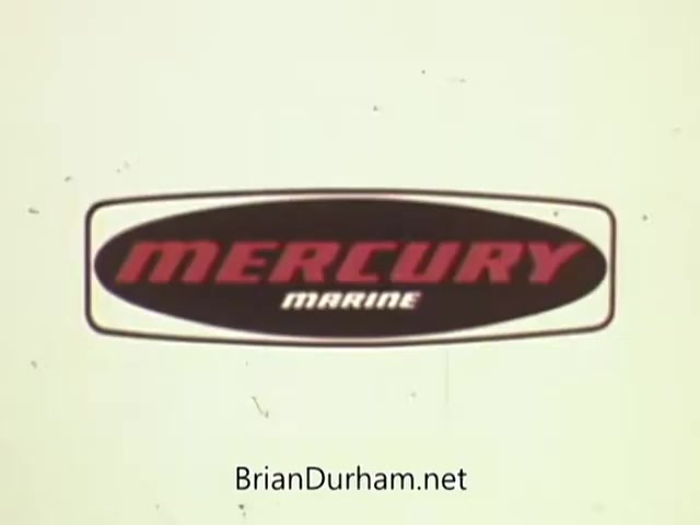 The still features the logo of Mercury Marine, prominently displayed with bold red lettering on a black oval background. The design is characteristic of 1960s branding, emphasizing the brand's identity in the outboard engine market. The clean, retro aesthetic reflects the era's commercial style, aiming to attract boating enthusiasts.