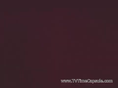 The still from the 'Pat Boone Savings Bonds PSA - Vietnam War Era' likely features Pat Boone delivering a message about the importance of U.S. savings bonds. In this context, Boone emphasizes their role as a significant contribution to national security and support for American troops in Vietnam. This was a common theme in public service announcements during the Vietnam War, aiming to encourage citizens to invest in bonds as a patriotic duty.