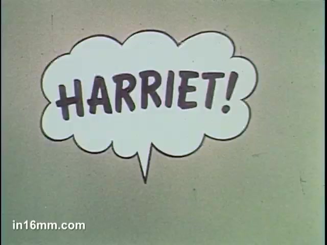 The still features a speech bubble prominently displaying the name 'HARriet!' in bold, cartoonish lettering. The background is simple and unadorned, allowing the text to take center stage. This moment likely signifies a call or announcement within the context of the Ajax Cleanser commercial, emphasizing a character's name or a key moment in the narrative. The overall aesthetic is reminiscent of vintage advertising, aiming to capture attention.