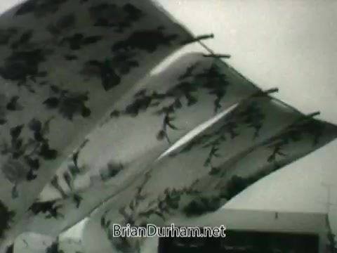 The still features several pieces of cloth or fabric hanging on a clothesline, gently waving in the breeze. The imagery likely symbolizes cleanliness and freshness, aligning with the theme of air quality and public health emphasized in the PSA from the 1960s. The overall tone is nostalgic, reflecting a time when such visuals were commonly used to communicate messages about health and environmental awareness.